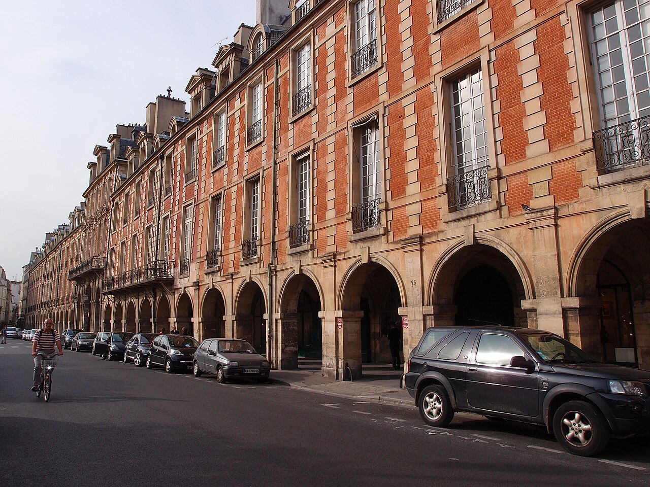 The arcades and garden at Place des Vosges in Paris